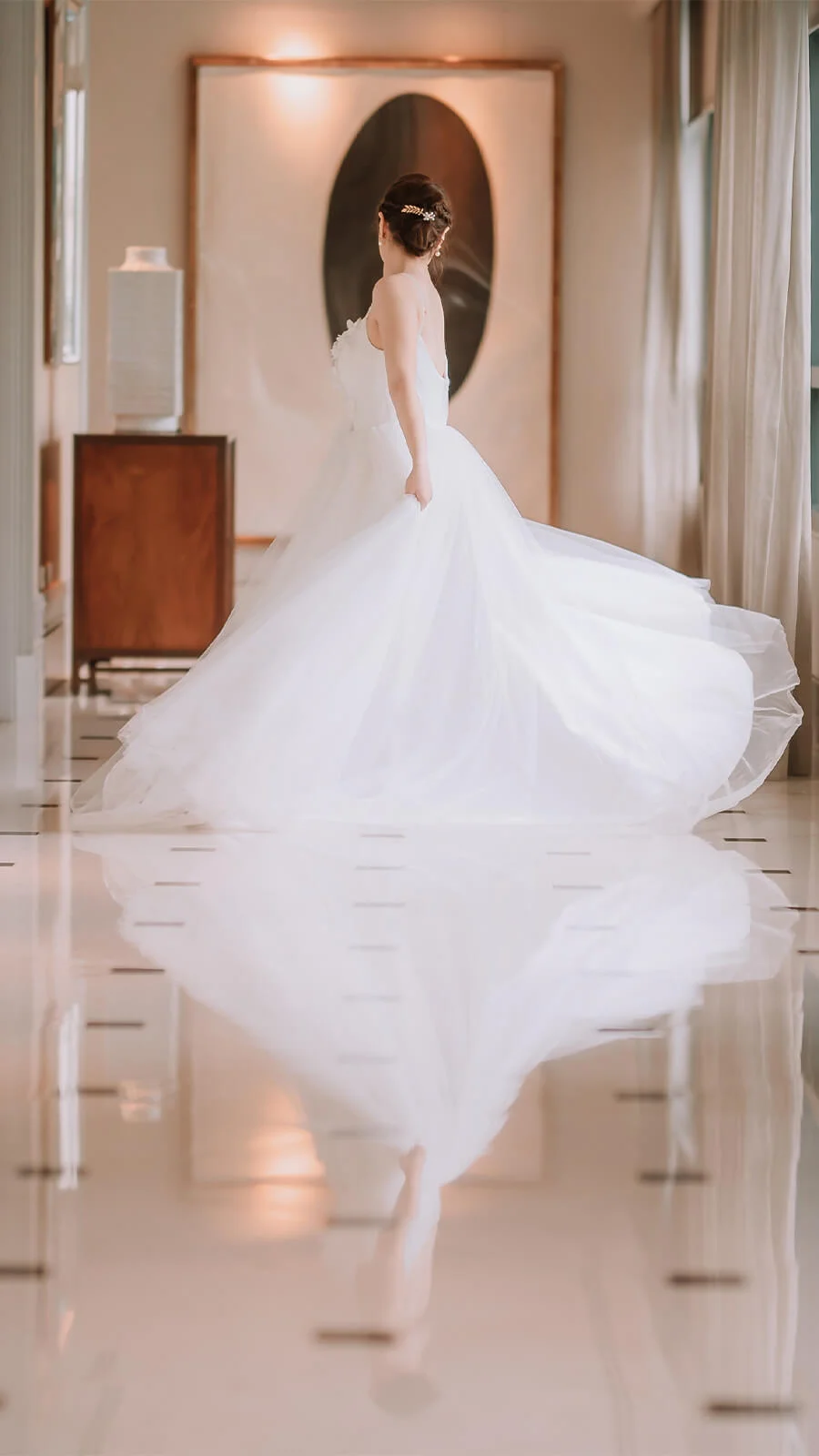 White gown, polished floor, a bride's reflection, a perfect moment.